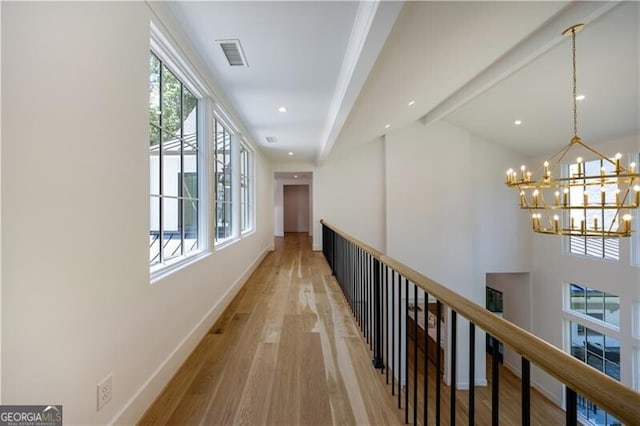 hallway featuring hardwood / wood-style floors and a notable chandelier