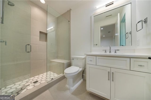 bathroom with toilet, an enclosed shower, tile patterned floors, and vanity