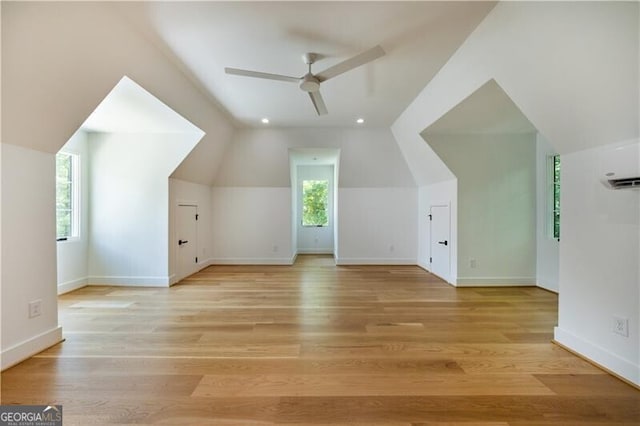 additional living space with ceiling fan, light hardwood / wood-style floors, and vaulted ceiling