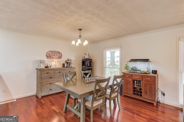 dining space featuring a notable chandelier, crown molding, dark hardwood / wood-style floors, and a textured ceiling