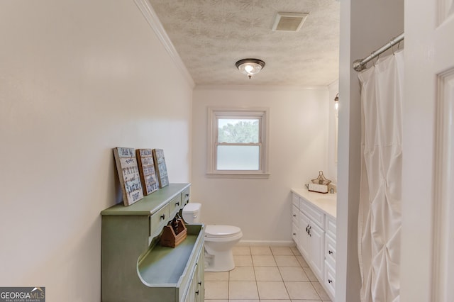 bathroom featuring vanity, toilet, tile patterned floors, and crown molding