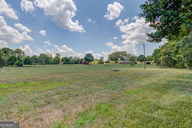 view of yard with a rural view