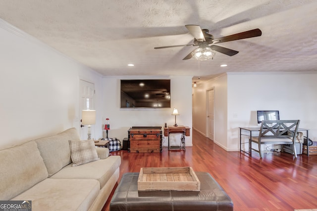 living room featuring hardwood / wood-style flooring, ornamental molding, and a textured ceiling