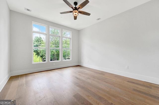 empty room featuring hardwood / wood-style flooring and ceiling fan