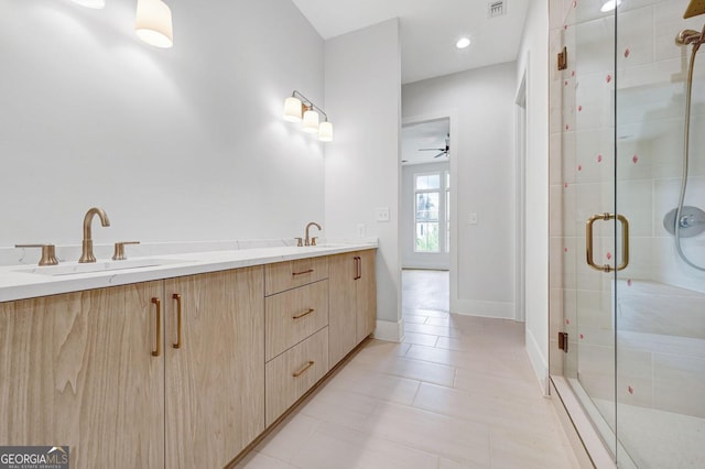 bathroom with vanity, a shower with shower door, and tile patterned flooring