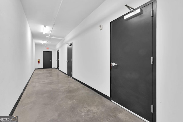 hallway with concrete floors