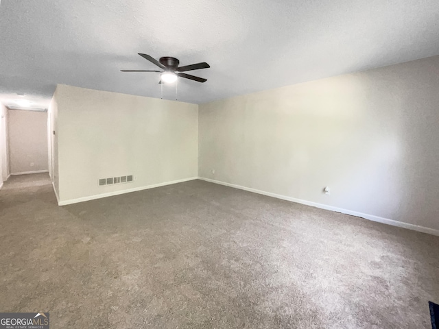 carpeted empty room with a textured ceiling and ceiling fan