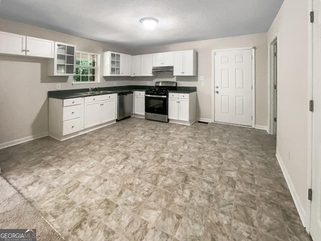 kitchen with sink, stainless steel appliances, a textured ceiling, and white cabinetry