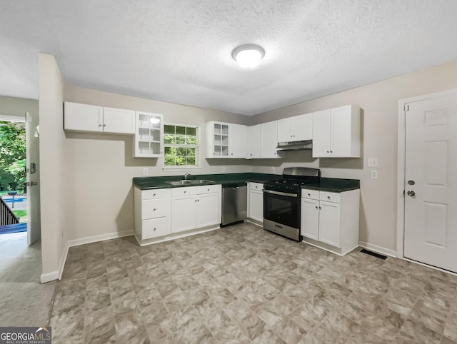 kitchen with appliances with stainless steel finishes, white cabinetry, and sink