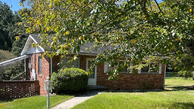 view of property hidden behind natural elements with a front lawn