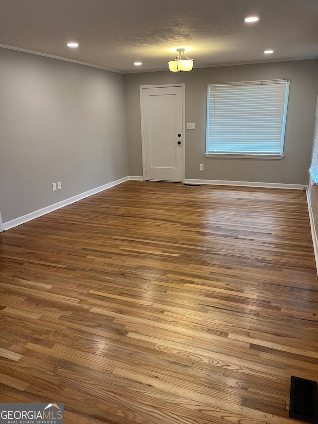 unfurnished room with hardwood / wood-style flooring