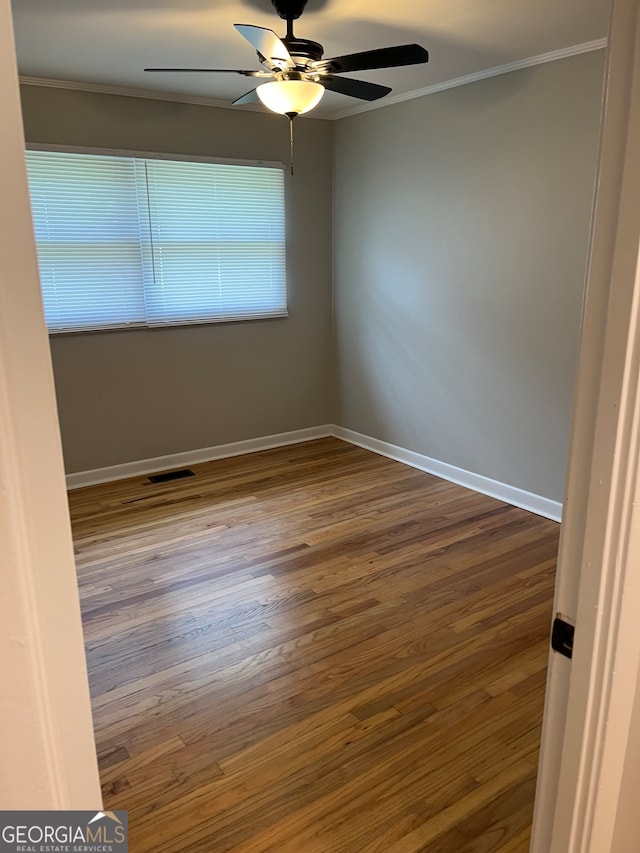 unfurnished room featuring ceiling fan, hardwood / wood-style floors, and crown molding