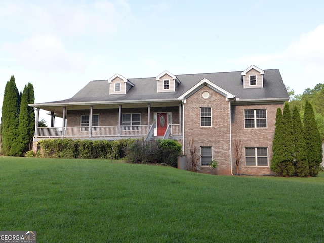 view of front of property with a front yard and covered porch