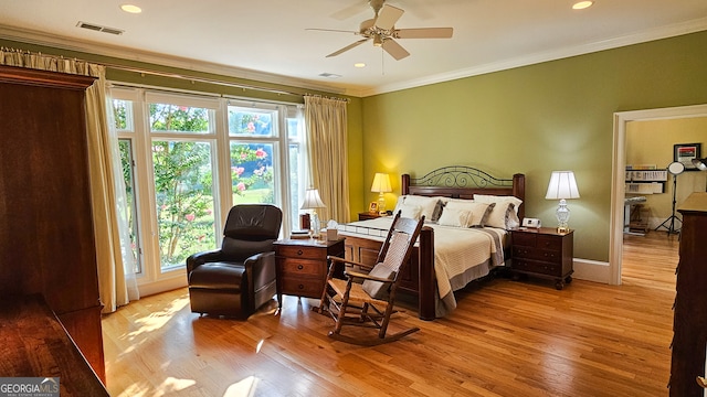 bedroom featuring ceiling fan, crown molding, and light wood-type flooring