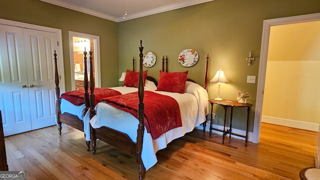 bedroom featuring a closet, ornamental molding, hardwood / wood-style flooring, and ensuite bathroom