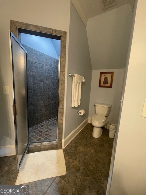 bathroom with tile patterned flooring, toilet, and walk in shower