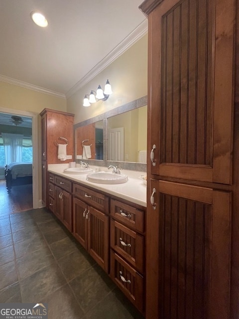 bathroom with vanity, ornamental molding, and tile patterned flooring