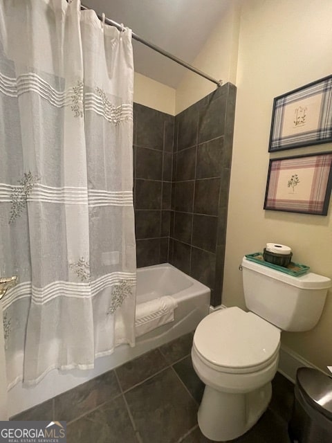 bathroom featuring toilet, tile patterned floors, and shower / tub combo with curtain