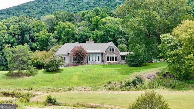 view of front of property featuring a front yard and a mountain view