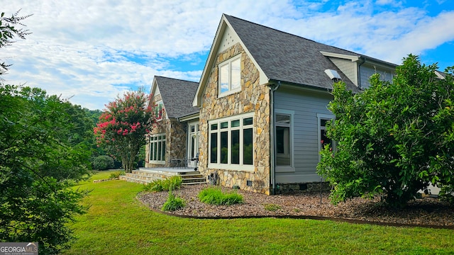 rear view of property with a yard