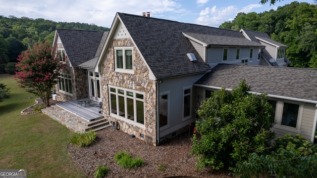 rear view of property with a lawn