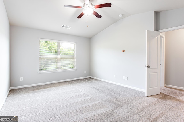 carpeted empty room with ceiling fan and lofted ceiling