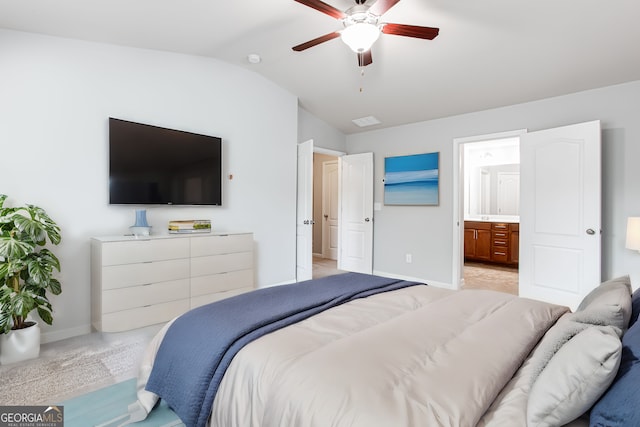 bedroom featuring ceiling fan, lofted ceiling, ensuite bath, and light carpet