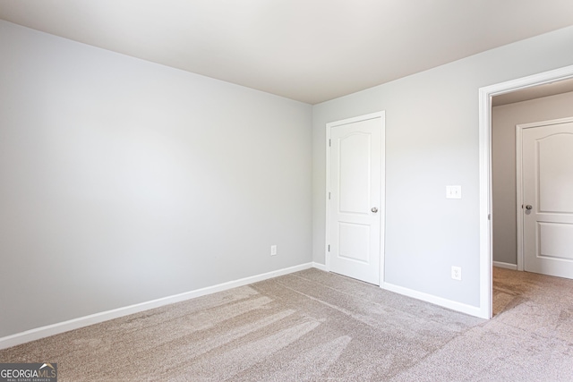 unfurnished bedroom with light colored carpet