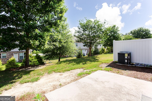 view of yard featuring central AC and a patio