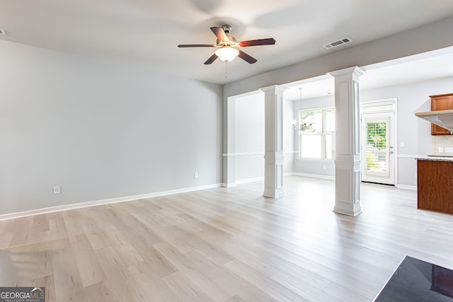 unfurnished living room featuring ceiling fan, light hardwood / wood-style floors, and ornate columns