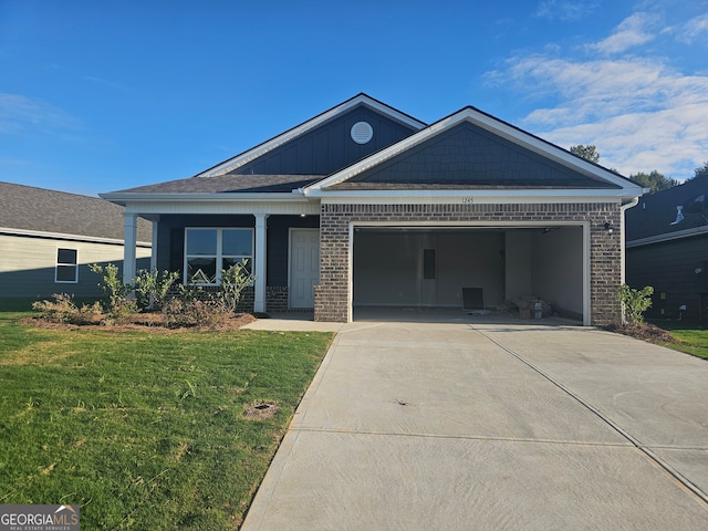 view of front of property with a front lawn and a garage