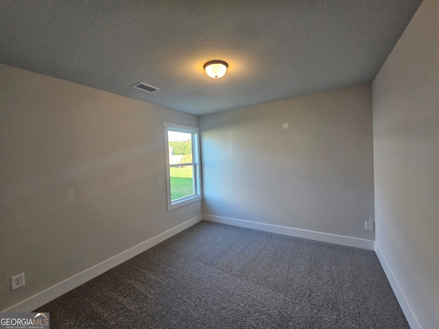 carpeted spare room featuring a textured ceiling