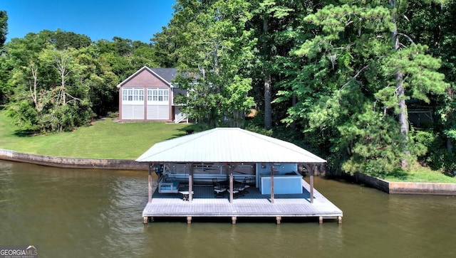 view of dock with a lawn, a water view, and boat lift