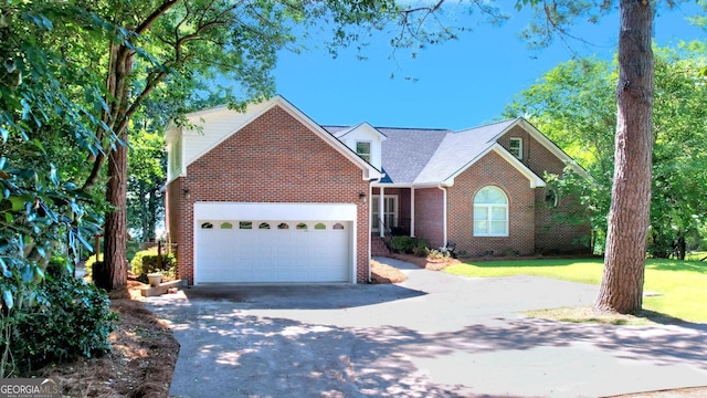 view of front of home with concrete driveway, brick siding, and an attached garage