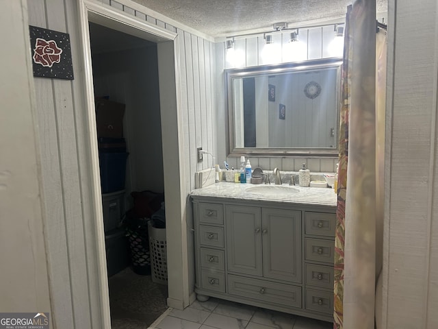 bathroom with vanity and a textured ceiling