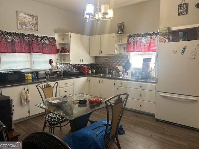 kitchen with tasteful backsplash, white cabinets, and white fridge