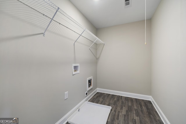 clothes washing area with hardwood / wood-style flooring, gas dryer hookup, hookup for an electric dryer, and washer hookup