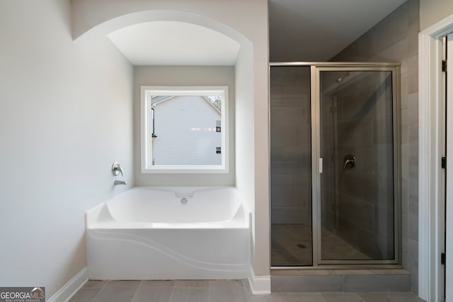 bathroom featuring tile patterned floors and plus walk in shower