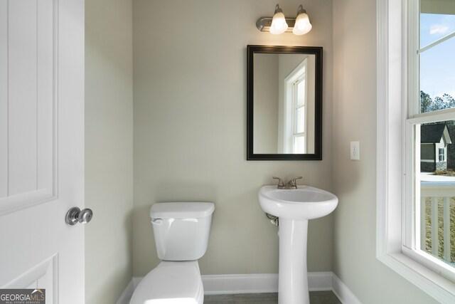 bathroom with toilet and plenty of natural light