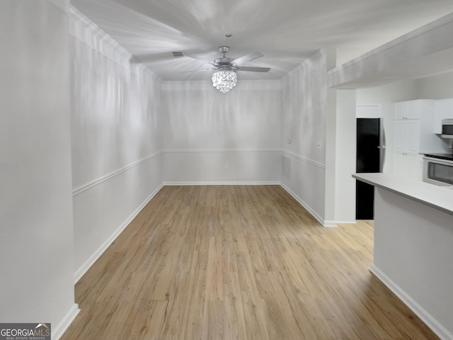 unfurnished dining area with light hardwood / wood-style flooring and ceiling fan