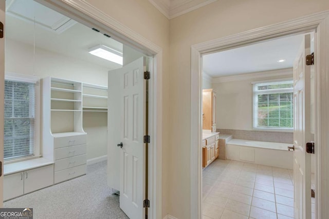 hallway with light carpet and crown molding