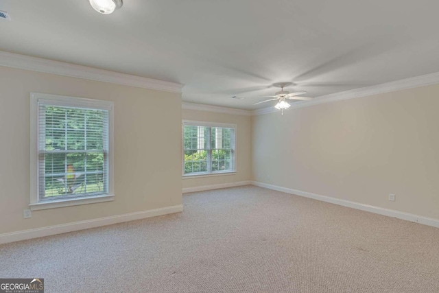 carpeted empty room with ornamental molding and ceiling fan