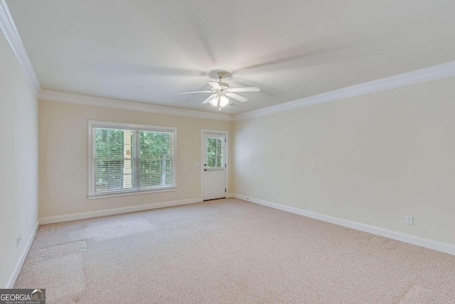 unfurnished room featuring light colored carpet, ceiling fan, and crown molding