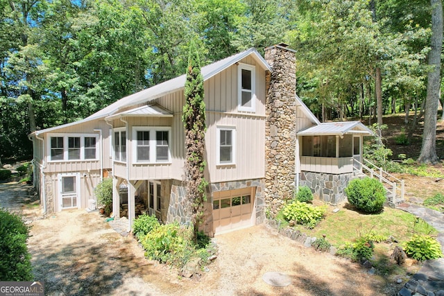 208 Colony Rd, Dillard, GA 30537 - view of front of home with a garage, dirt driveway, a chimney, and stone siding