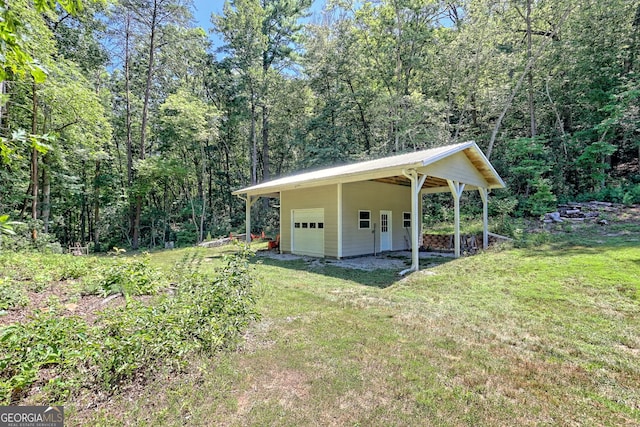 exterior space with a garage and a lawn