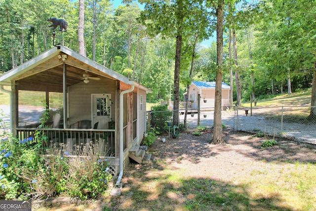 view of yard featuring an outbuilding and ceiling fan