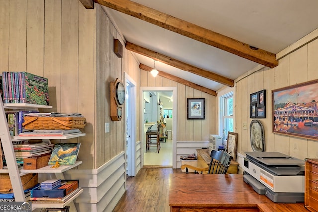 office area featuring vaulted ceiling with beams, hardwood / wood-style floors, and wooden walls