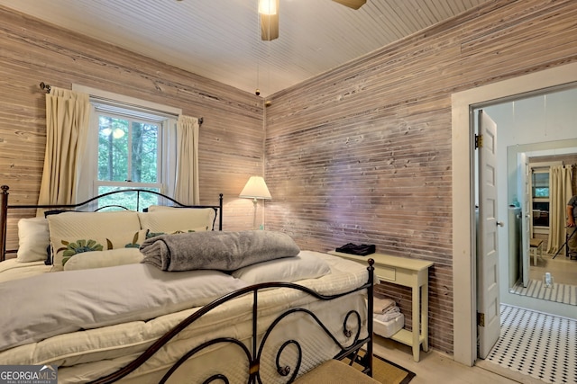 bedroom featuring wood ceiling, light tile patterned floors, wooden walls, and ceiling fan