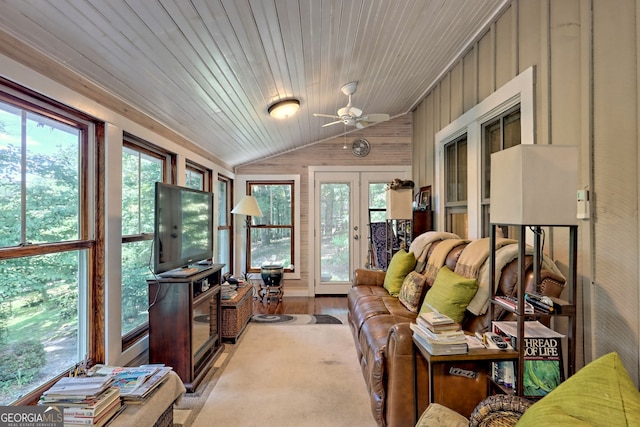 interior space with ceiling fan, hardwood / wood-style floors, wood walls, lofted ceiling, and wood ceiling