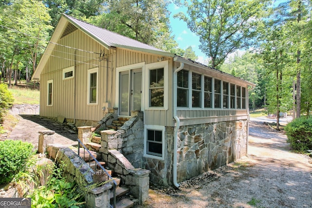 208 Colony Rd, Dillard, GA 30537 - view of front of home with stone siding, a metal roof, entry steps, and board and batten siding
